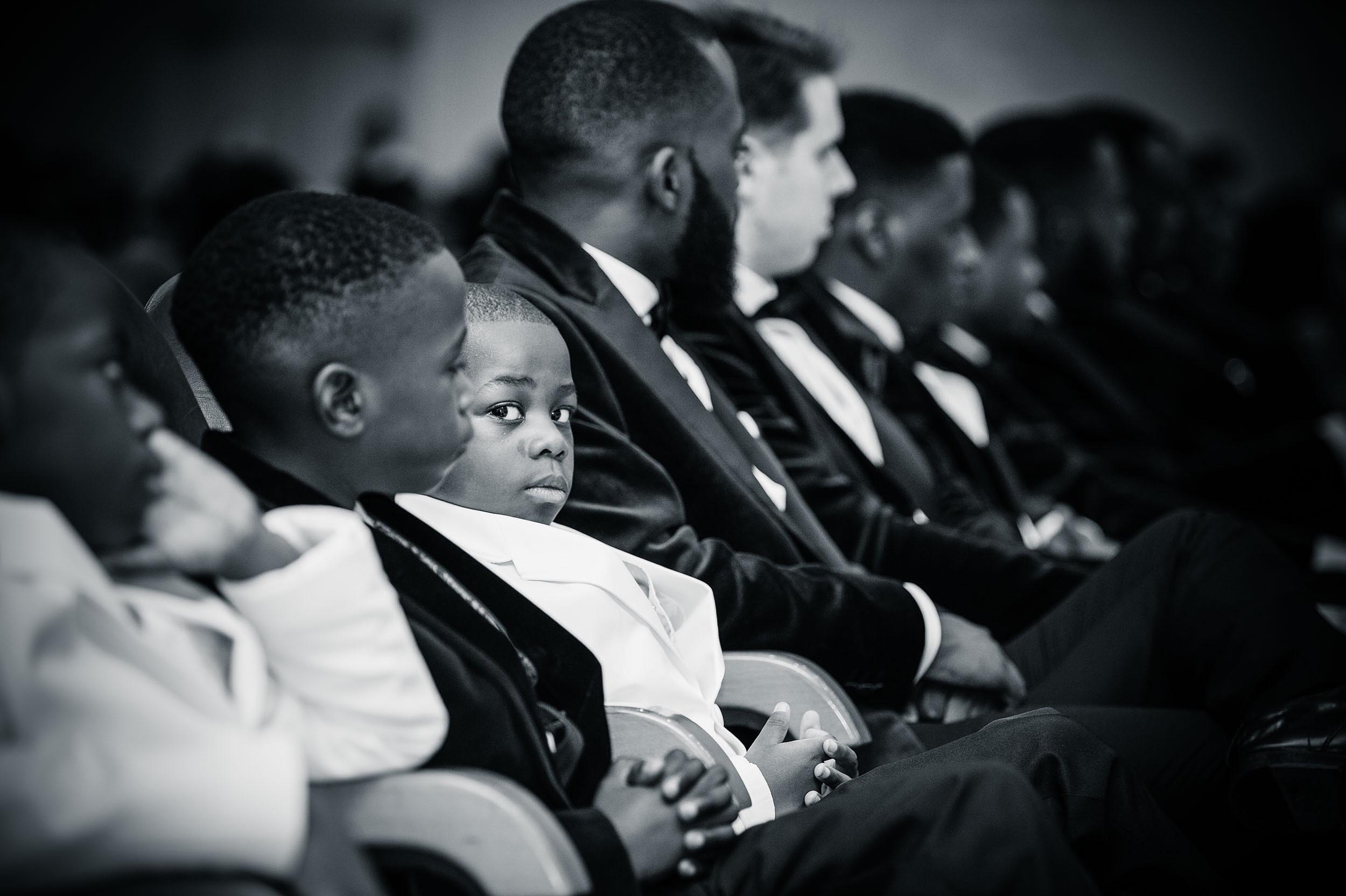 boy-sitting-wedding-ceremony-uckg-church-kilburn-north-london-photographer