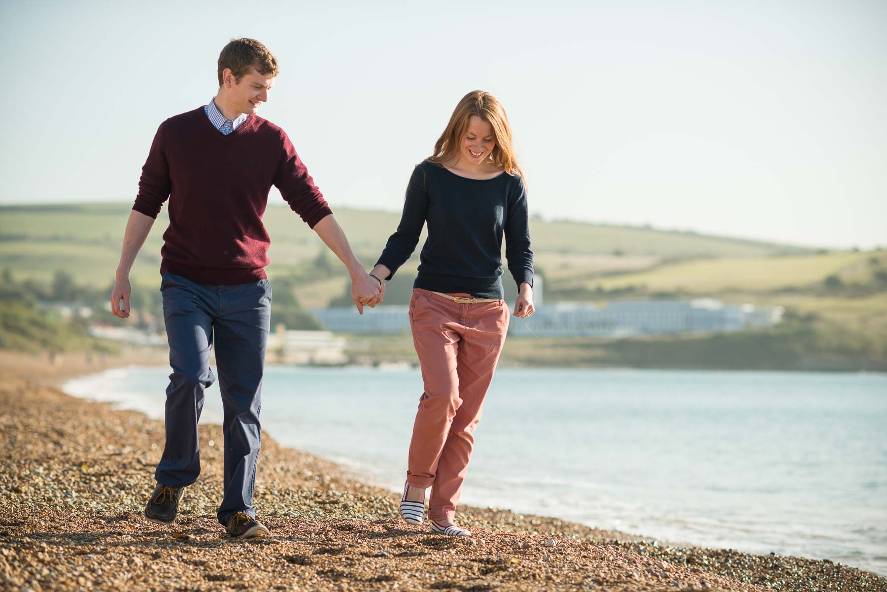 weymouth-beach-zoe-engagement-shoot-happy-couple-walking-10